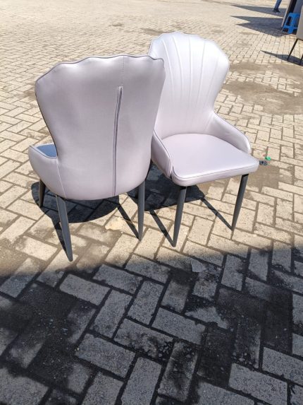 Elegant Upholstered Faux Dining Chairs with luxurious faux fabric upholstery and sleek wooden frames, perfect for modern dining rooms.