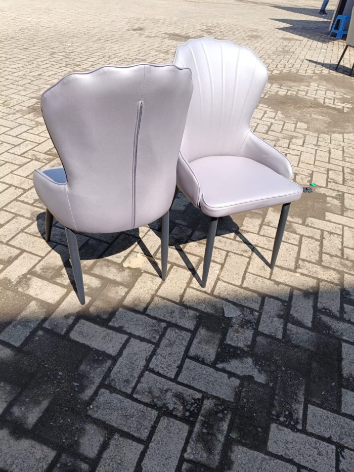 Elegant Upholstered Faux Dining Chairs Elegant Upholstered Faux Dining Chairs with luxurious faux fabric upholstery and sleek wooden frames, perfect for modern dining rooms.